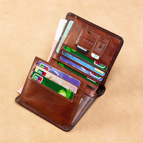 Brown leather wallet with multiple cards on a beige background