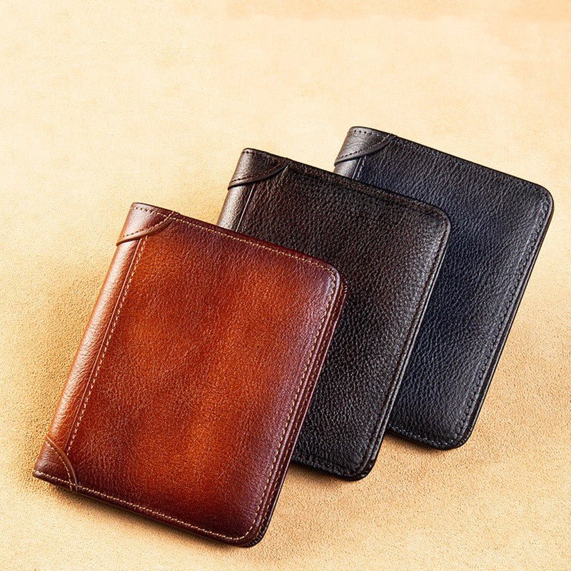 Three leather wallets in brown, black, and blue on a beige background
